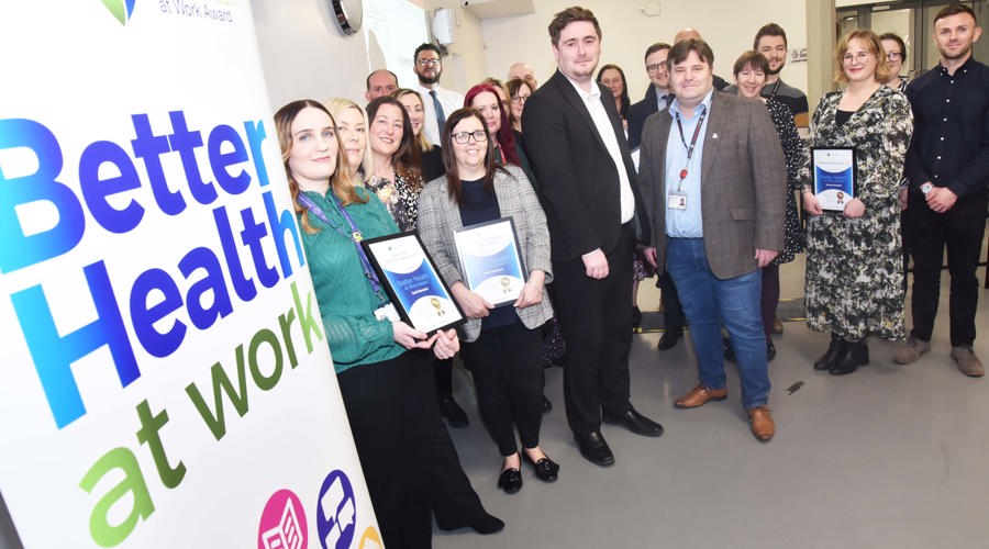 Middlesbrough Mayor Chris Cooke and Redcar & Cleveland Council leader Alec Brown (centre, left and right) with category winners in the 2024 Better Health At Work Awards celebration event at Middlesbrough Town Hall