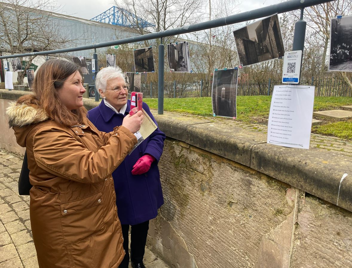 Edna Reddy and Cllr Storey explore a picture display and QR codes telling the hidden stories of women in Middlesbrough